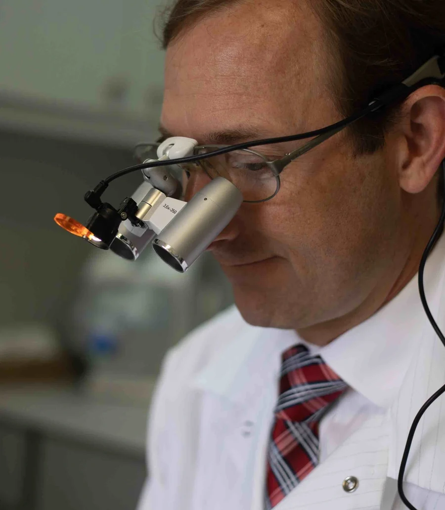 Dr. Jamie Callahan at work at Bayou Dental, wearing magnifying loupes.